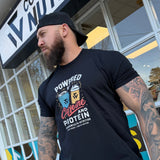 Man wearing a black t-shirt with graphic design in front of a store named 'Common Sense Nutrition'.