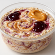 peanut butter and jelly flavored, overnight oats in a clear plastic bowl, with a white or light background